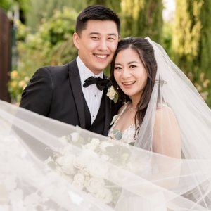 wedding veils can be really fun to play with. this smiling wedding couple is at Palm Event Center in Pleasanton California. 
