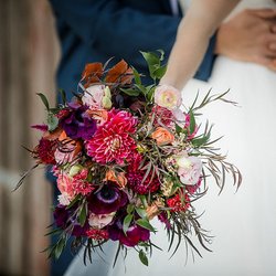 This Burgundy, peach, blush, and merlot bouquet was inspired by wine country. Taking all the beautiful hues found in the wine grapes of California, we asked for the florist to give us a beautiful and moody bridal bouquet. Vanda Floral delivered on this amazing flower arrangement! With wine colors and hints of fall, we were ready for this October wedding during harvest. The Haven at Tomales gave us a lovely barn backdrop for the pops of burgundy colors. Photo Credit: Jade Turgel photography 