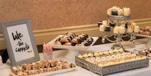 Wedding dessert bar with cannoli and cupakes. 